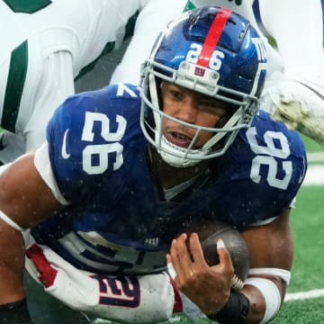 The New York Giants' running back Saquon Barkley (26) is shown with the ball against the Jets. The Giants' star running back is on the verge of hitting free agency and there is plenty of debate over his uncertain future with Big Blue.
