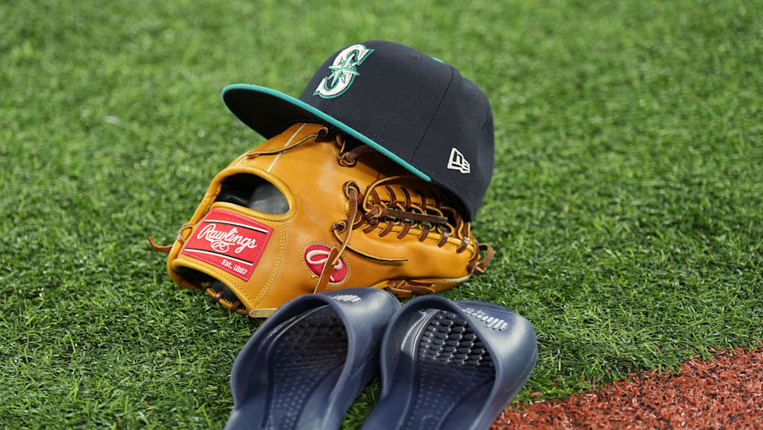 Oct 12, 2025; Toronto, Ontario, CAN; A Seattle Mariners players cap, mitt and slippers on the field prior to game one of the ALCS round for the 2025 MLB playoffs at Rogers Centre. Mandatory Credit: Nick Turchiaro-Imagn Images