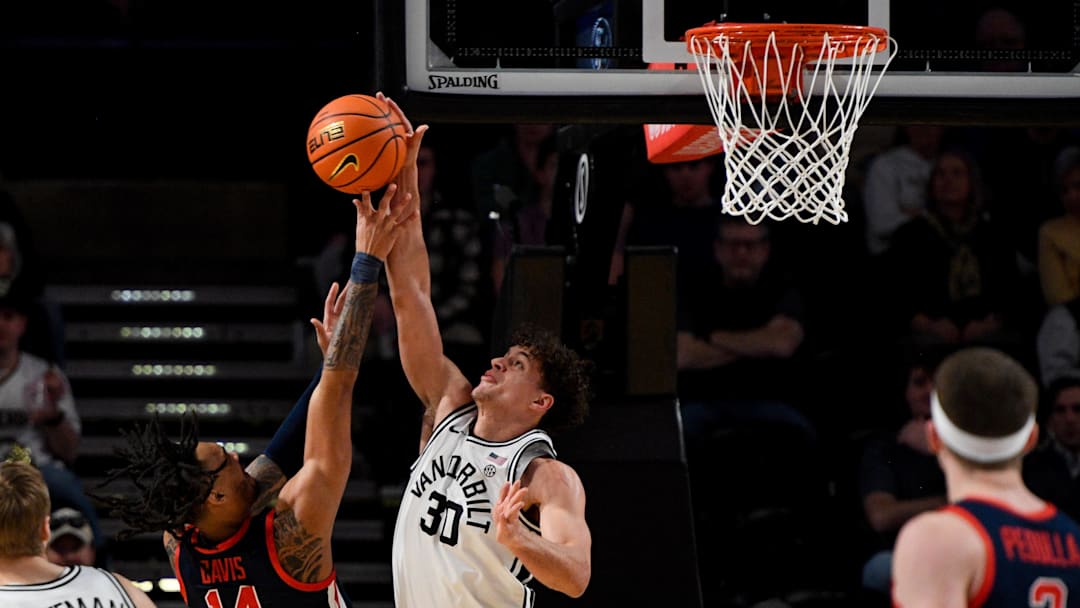 Feb 22, 2025; Nashville, Tennessee, USA; Vanderbilt Commodores guard Chris Manon (30) blocks the shot of Mississippi Rebels guard Dre Davis (14) during the first half at Memorial Gymnasium. Mandatory Credit: Steve Roberts-Imagn Images