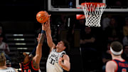 Feb 22, 2025; Nashville, Tennessee, USA; Vanderbilt Commodores guard Chris Manon (30) blocks the shot of Mississippi Rebels guard Dre Davis (14) during the first half at Memorial Gymnasium. Mandatory Credit: Steve Roberts-Imagn Images