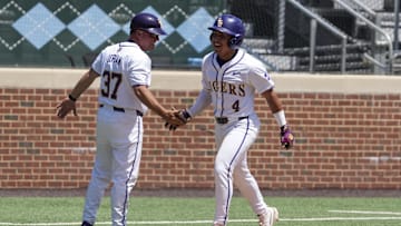 May 31, 2024; Chapel Hill, NC, USA; LSU infielder Steven Milam (4) celebrates his winning home run with his third base coach during the NCAA Regional in Chapel Hill. Mandatory Credit: Jim Dedmon-Imagn Images