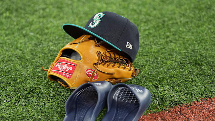 Oct 12, 2025; Toronto, Ontario, CAN; A Seattle Mariners players cap, mitt and slippers on the field prior to game one of the ALCS round for the 2025 MLB playoffs at Rogers Centre. Mandatory Credit: Nick Turchiaro-Imagn Images