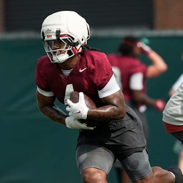 July 30, 2025; Tuscaloosa, AL, USA; Running back Daniel Hill makes a cut around running backs coach Robert Gillespie during the first practice session of the preseason for the Alabama Crimson Tide.
