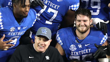 Kentucky   s coach Mark Stoops posses with the team and the Governor   s Cup trophy for winning the game against Louisville.Nov. 26, 2022

Kentuckylouisville 17