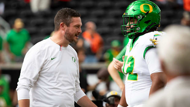 Oregon Coach Dan Lanning and Center Iapani Laloulu