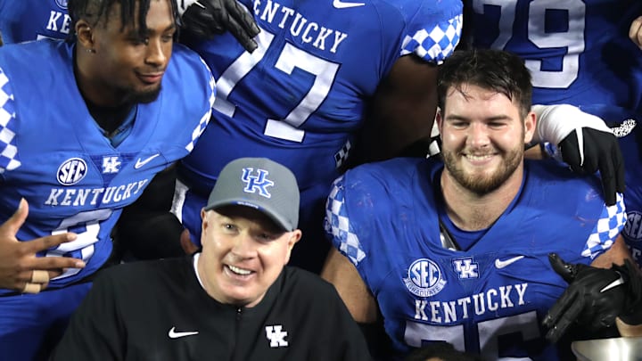 Kentucky   s coach Mark Stoops posses with the team and the Governor   s Cup trophy for winning the game against Louisville.Nov. 26, 2022

Kentuckylouisville 17