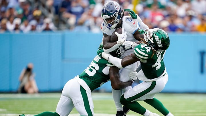 Tennessee Titans running back Tyjae Spears (2) is tackled by New York Jets linebacker Quincy Williams (56) linebacker Jamien Sherwood (44) during the second quarter at Nissan Stadium in Nashville, Tenn., Sunday, Sept. 15, 2024.