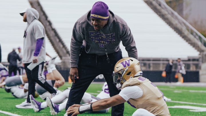 John Richardson chats up quarterback Demond Williams Jr. during stretching. 