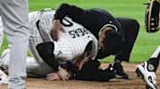 Chicago White Sox first baseman Miguel Vargas (20) is examined  after being injured against the New York Yankees at Rate Field. 