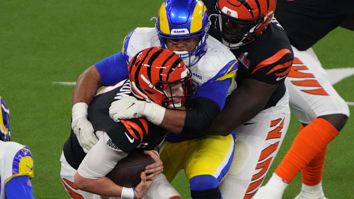 Feb 13, 2022; Inglewood, California, USA; Los Angeles Rams defensive end Aaron Donald (99) sacks Cincinnati Bengals quarterback Joe Burrow (9) in the third quarter in Super Bowl LVI at SoFi Stadium. Mandatory Credit: Kirby Lee-Imagn Images