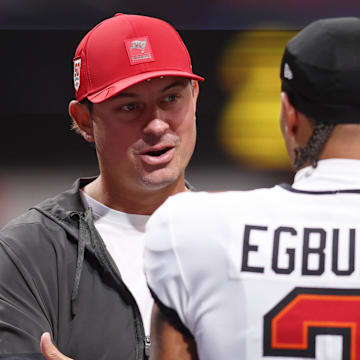 Sep 7, 2025; Atlanta, Georgia, USA; Tampa Bay Buccaneers offensive coordinator Josh Grizzard talks with wide receiver Emeka Egbuka (2) before the game against the Atlanta Falcons at Mercedes-Benz Stadium. Mandatory Credit: Brett Davis-Imagn Images