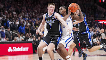 Nov 12, 2024; Atlanta, Georgia, USA; Kentucky Wildcats guard Otega Oweh (00) tries to get past Duke Blue Devils guard Kon Knueppel (7) during the second half at State Farm Arena. Mandatory Credit: Dale Zanine-Imagn Images