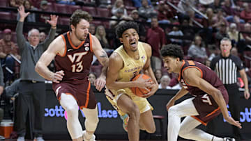 Jan 29, 2025; Tallahassee, Florida, USA; Florida State Seminoles guard Bostyn Holt (3) drives to the net past Virginia Tech Hokies forward Ben Burnham (13) during the first half at Donald L. Tucker Center. Mandatory Credit: Melina Myers-Imagn Images
