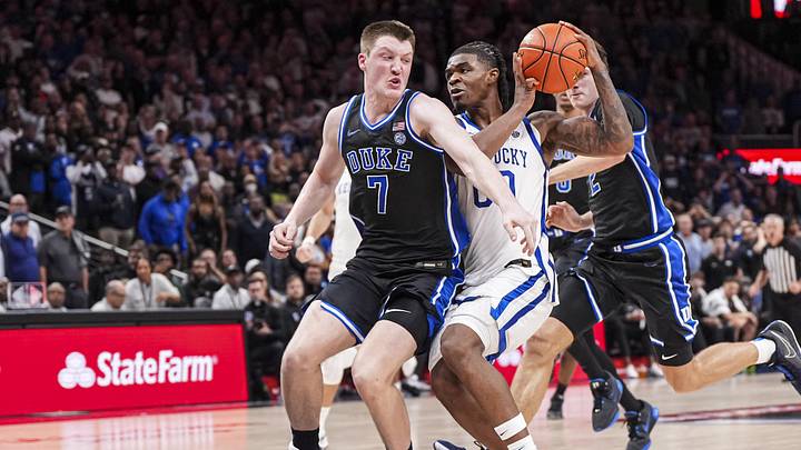 Nov 12, 2024; Atlanta, Georgia, USA; Kentucky Wildcats guard Otega Oweh (00) tries to get past Duke Blue Devils guard Kon Knueppel (7) during the second half at State Farm Arena. Mandatory Credit: Dale Zanine-Imagn Images