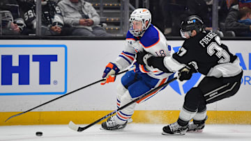 Edmonton Oilers left wing Zach Hyman (18) moves the puck against Los Angeles Kings left wing Warren Foegele (37)
