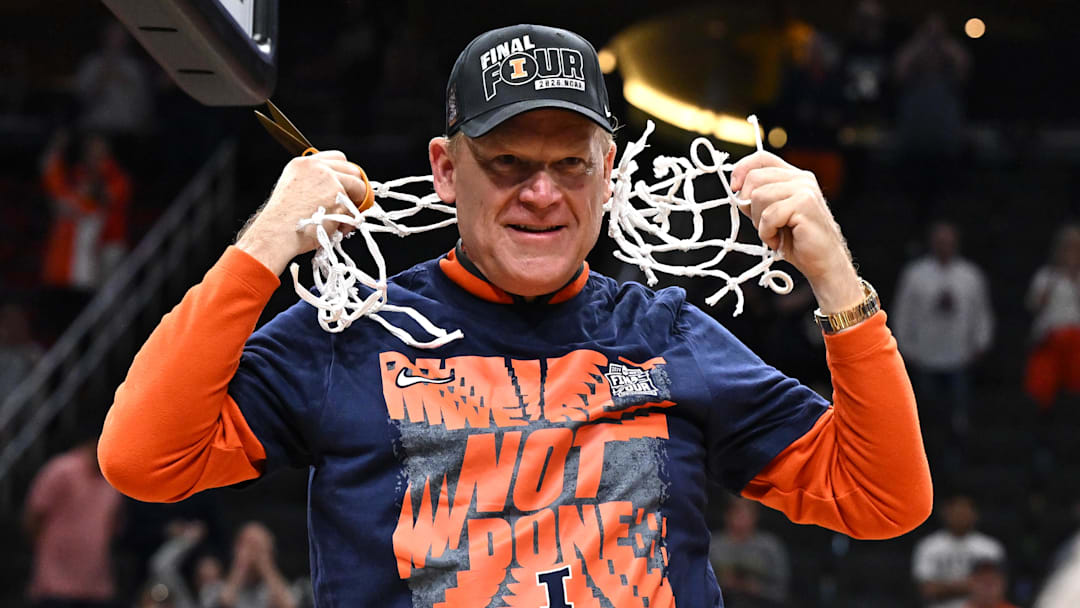 Mar 28, 2026; Houston, TX, USA; Illinois Fighting Illini head coach Brad Underwood celebrates after cutting down the net after defeating the Iowa Hawkeyes in an Elite Eight game of the South Regional of the men's 2026 NCAA Tournament at Toyota Center. Mandatory Credit: Maria Lysaker-Imagn Images