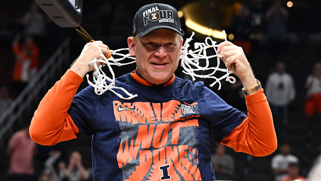 Mar 28, 2026; Houston, TX, USA; Illinois Fighting Illini head coach Brad Underwood celebrates after cutting down the net after defeating the Iowa Hawkeyes in an Elite Eight game of the South Regional of the men's 2026 NCAA Tournament at Toyota Center. Mandatory Credit: Maria Lysaker-Imagn Images