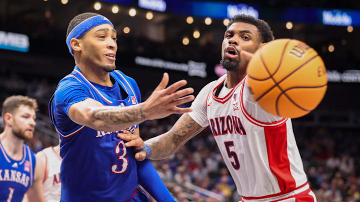 Mar 13, 2025; Kansas City, MO, USA; Kansas Jayhawks guard Dajuan Harris Jr. (3) passes the ball around Arizona Wildcats guard KJ Lewis (5) during the second half at T-Mobile Center. Mandatory Credit: William Purnell-Imagn Images
