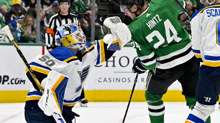 Apr 17, 2024; Dallas, Texas, USA; St. Louis Blues goaltender Jordan Binnington (50) makes a glove save in front of Dallas Stars center Roope Hintz (24) during the second period at the American Airlines Center. Mandatory Credit: Jerome Miron-USA TODAY Sports