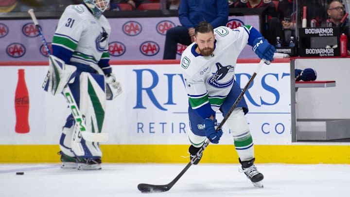 Nov 23, 2024; Ottawa, Ontario, CAN; Vancouver Canucks defenseman Filip Hronek (17) shoots  the puck during warmup prior to game against the Ottawa Senators at the Canadian Tire Centre. Mandatory Credit: Marc DesRosiers-Imagn Images