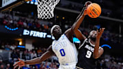 Mar 20, 2025; Denver, CO, USA; Brigham Young Cougars forward Mawot Mag (0) and VCU Rams forward Luke Bamgboye (9) go after a rebound during the second half in the first round of the NCAA Tournament at Ball Arena. Mandatory Credit: Ron Chenoy-Imagn Images
