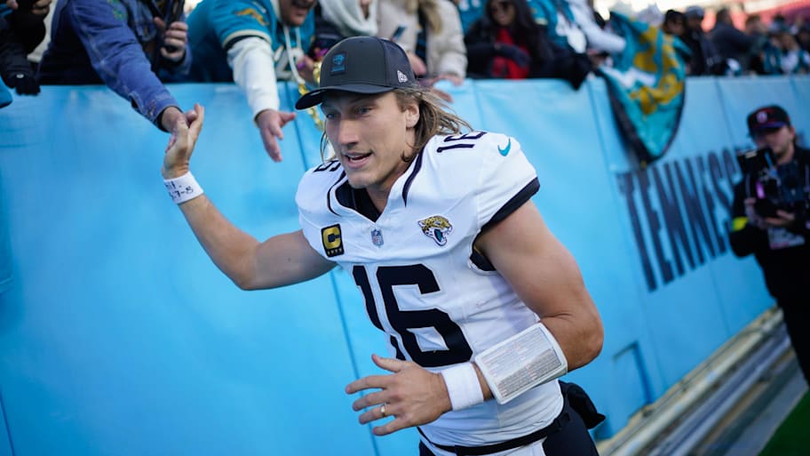 Jacksonville Jaguars quarterback Trevor Lawrence gets high-fives from fans after a win