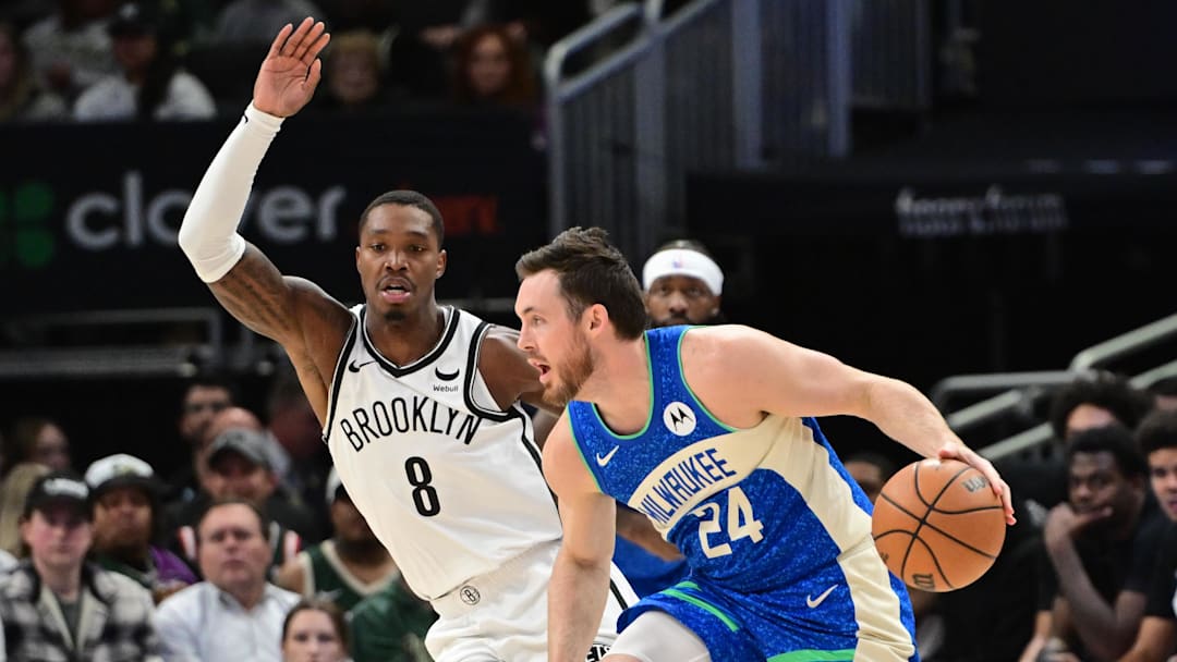 Mar 21, 2024; Milwaukee, Wisconsin, USA; Milwaukee Bucks guard Pat Connaughton (24) drives for the basket against Brooklyn Nets guard Lonnie Walker IV (8) in the third quarter at Fiserv Forum. Mandatory Credit: Benny Sieu-Imagn Images