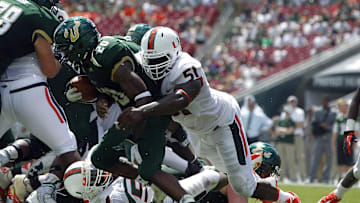 Sep 28, 2013; Tampa, FL, USA;Miami Hurricanes defensive lineman Shayon Green (51) tackles South Florida Bulls running back Marcus Shaw (20) during the first half at Raymond James Stadium. Mandatory Credit: Kim Klement-Imagn Images