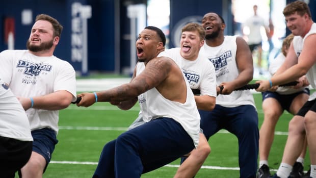 Penn State football players play tug-of-war during a fundraising event.