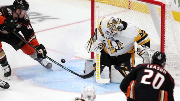 Nov 7, 2023; Anaheim, California, USA; Anaheim Ducks left wing Ross Johnston (44) attempts to shoot a puck against Pittsburgh Penguins goaltender Magnus Hellberg (45) during the third period at Honda Center. Mandatory Credit: Kiyoshi Mio-USA TODAY Sports