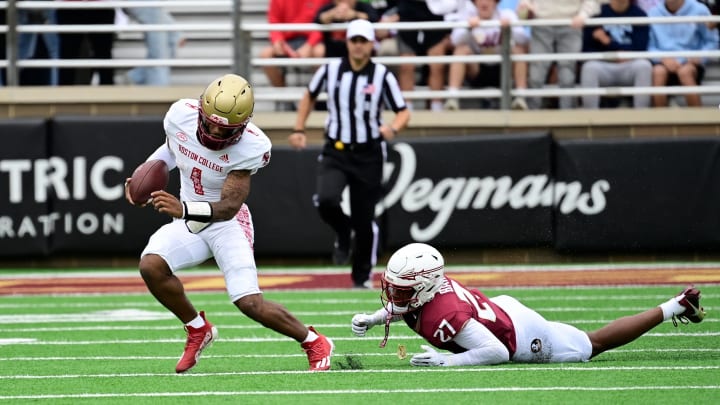 Sep 16, 2023; Chestnut Hill, Massachusetts, USA; Boston College Eagles quarterback Thomas Castellanos (1) breaks a tackle by Florida State Seminoles defensive back Ashlynd Barker (27) during the first half at Alumni Stadium. Mandatory Credit: Eric Canha-USA TODAY Sports