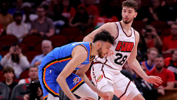 Apr 4, 2025; Houston, Texas, USA; Oklahoma City Thunder forward Chet Holmgren (7) handles the ball against Houston Rockets center Alperen Sengun (28) during the first quarter at Toyota Center. Mandatory Credit: Erik Williams-Imagn Images