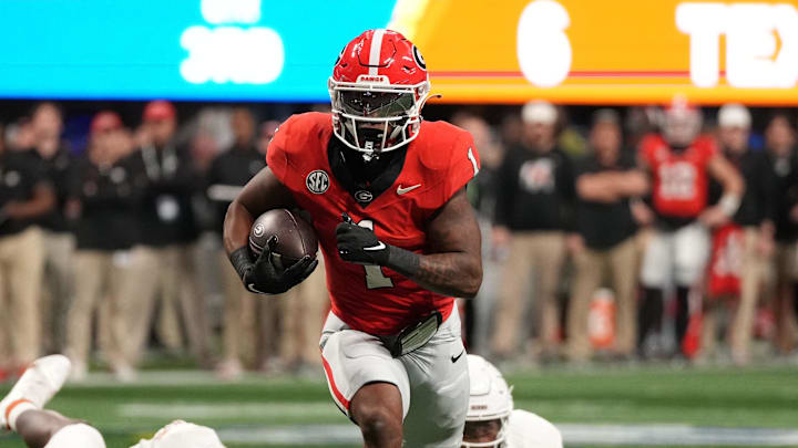 Georgia Bulldogs running back Trevor Etienne rushes for a touchdown against the Texas Longhorns during the second half in the 2024 SEC championship game at Mercedes-Benz Stadium.