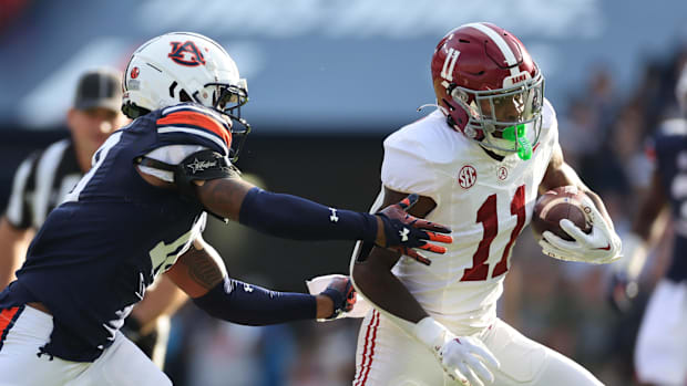 Auburn Tigers safety Zion Puckett (10) closes in on Alabama Crimson Tide wide receiver Malik Benson (11) 