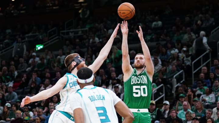 Apr 12, 2024; Boston, Massachusetts, USA; Boston Celtics guard Svi Mykhailiuk (50) shoots against Charlotte Hornets forward Davis Bertans (9) in the second quarter at TD Garden. Mandatory Credit: David Butler II-USA TODAY Sports