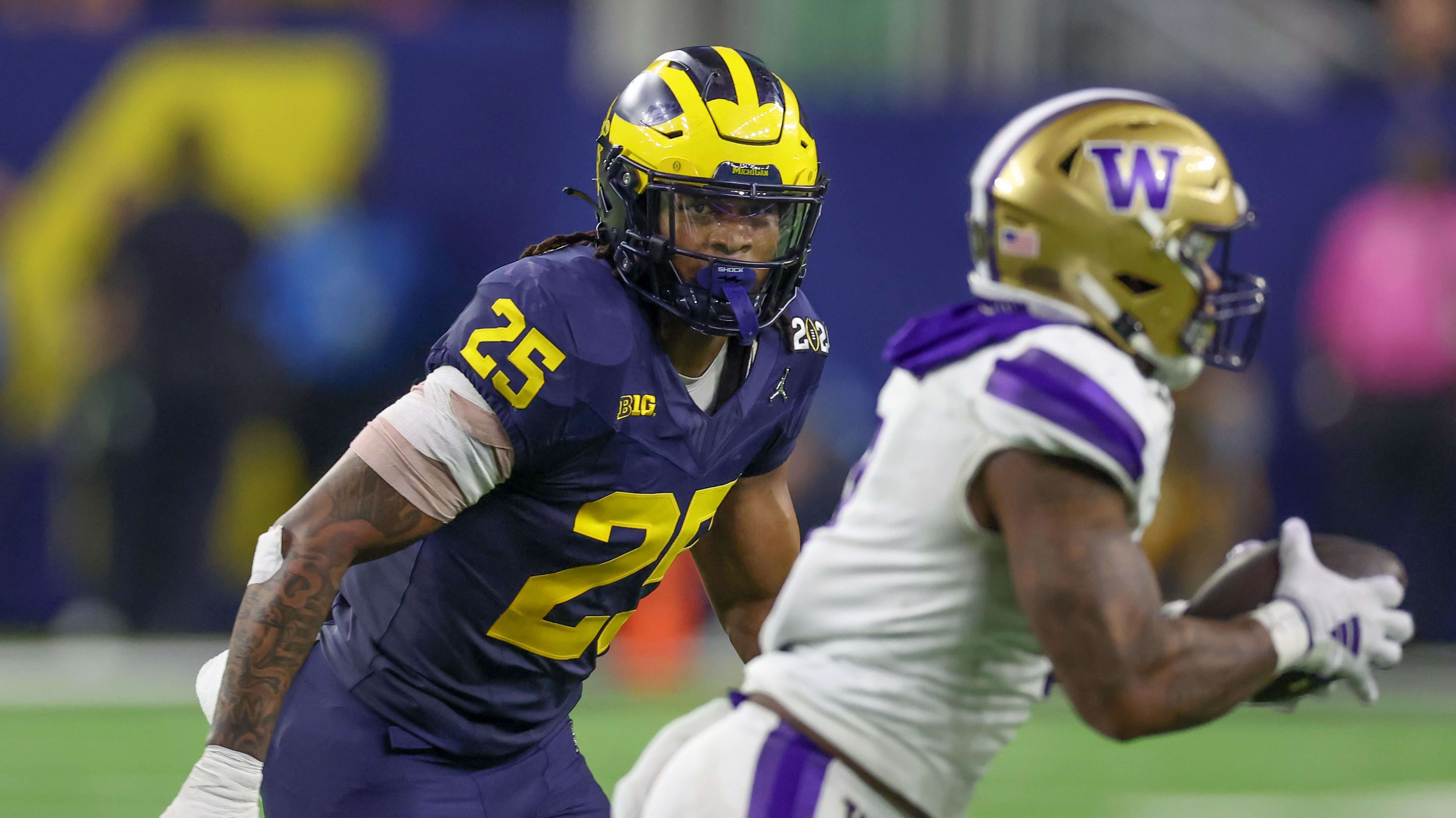 Jan 8, 2024; Houston, TX, USA;Washington Huskies quarterback Michael Penix Jr. (9) is chased by Junior Colson (25).