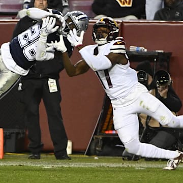 Dallas Cowboys cornerback DaRon Bland intercepts a pass intended for Commanders wide receiver Terry McLaurin.