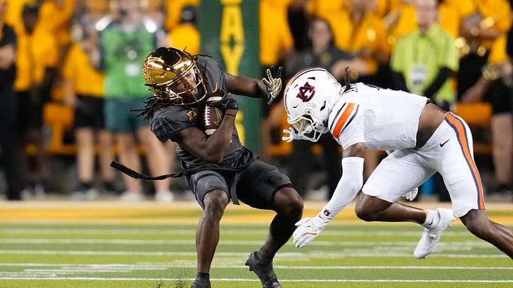 Aug 29, 2025; Waco, Texas, USA; Baylor Bears wide receiver Kole Wilson (2) makes a catch as Auburn Tigers safety Champ Anthony (1) defends during the first half at McLane Stadium. Mandatory Credit: Chris Jones-Imagn Images