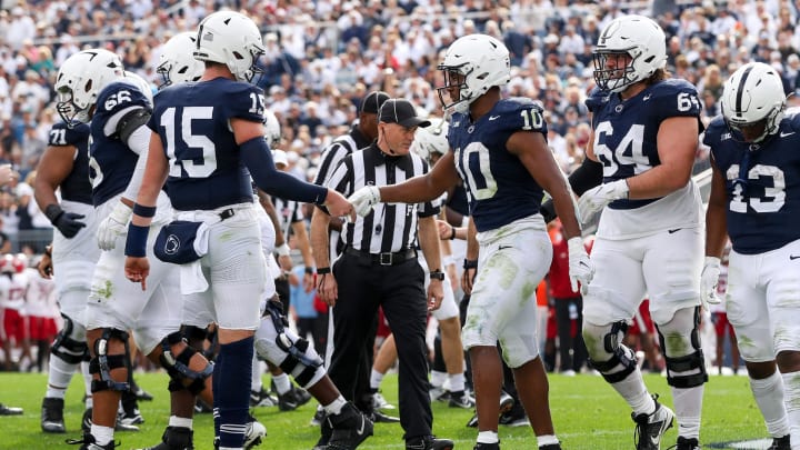 Penn State Nittany Lions quarterback Drew Allar (15) congratulates running back Nicholas Singleton after a touchdown at Beaver Stadium. 