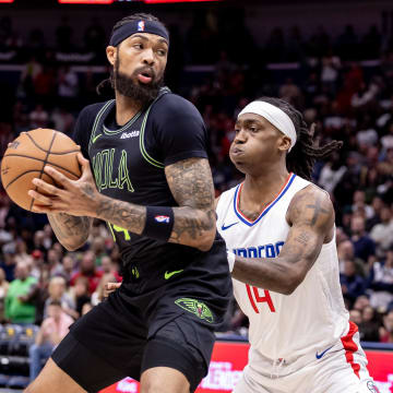 Mar 15, 2024; New Orleans, Louisiana, USA;  New Orleans Pelicans forward Brandon Ingram (14) dribbles against LA Clippers guard Terance Mann (14) during the first half at Smoothie King Center.