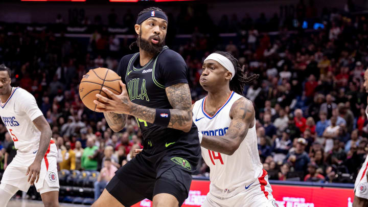 Mar 15, 2024; New Orleans, Louisiana, USA;  New Orleans Pelicans forward Brandon Ingram (14) dribbles against LA Clippers guard Terance Mann (14) during the first half at Smoothie King Center.