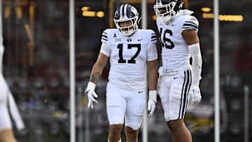 Sep 6, 2024; Dallas, Texas, USA; Brigham Young Cougars linebacker Jack Kelly (17) and linebacker Isaiah Glasker (16) in action during the game between the Southern Methodist Mustangs and the Brigham Young Cougars at Gerald J. Ford Stadium. Mandatory Credit: Jerome Miron-Imagn Images