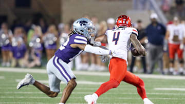 Sep 13, 2024; Manhattan, Kansas, USA; Kansas State Wildcats safety Nickendre Stiger (12) chases Arizona Wildcats wide receiver Tetairoa McMillan (4) during the third  quarter at Bill Snyder Family Football Stadium. Mandatory Credit: Scott Sewell-Imagn Images
