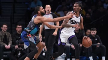 Apr 7, 2024; Brooklyn, New York, USA; Sacramento Kings guard Keon Ellis (23) dribbles against Brooklyn Nets forward Mikal Bridges (1) during the second half at Barclays Center. Mandatory Credit: Vincent Carchietta-USA TODAY Sports