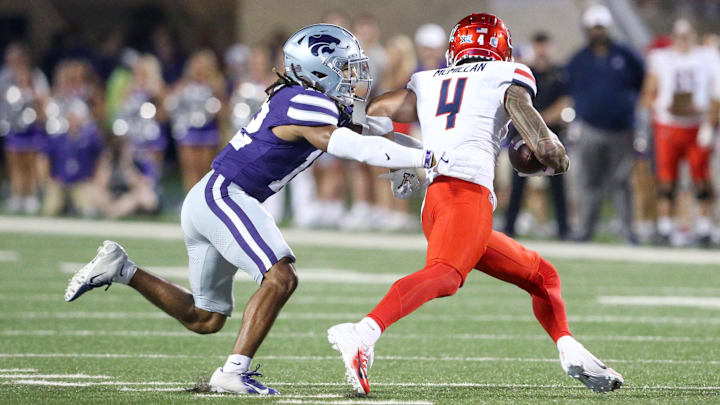 Sep 13, 2024; Manhattan, Kansas, USA; Kansas State Wildcats safety Nickendre Stiger (12) chases Arizona Wildcats wide receiver Tetairoa McMillan (4) during the third  quarter at Bill Snyder Family Football Stadium.