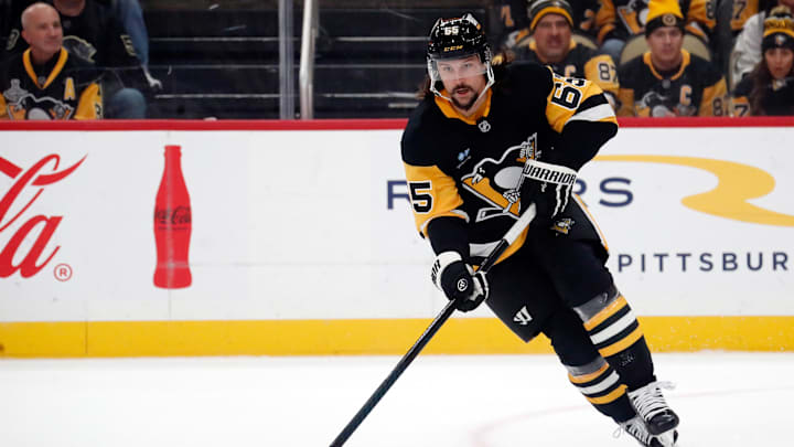 Oct 16, 2024; Pittsburgh, Pennsylvania, USA;  Pittsburgh Penguins defenseman Erik Karlsson (65) moves the puck against the Buffalo Sabres during the first period at PPG Paints Arena. Mandatory Credit: Charles LeClaire-Imagn Images