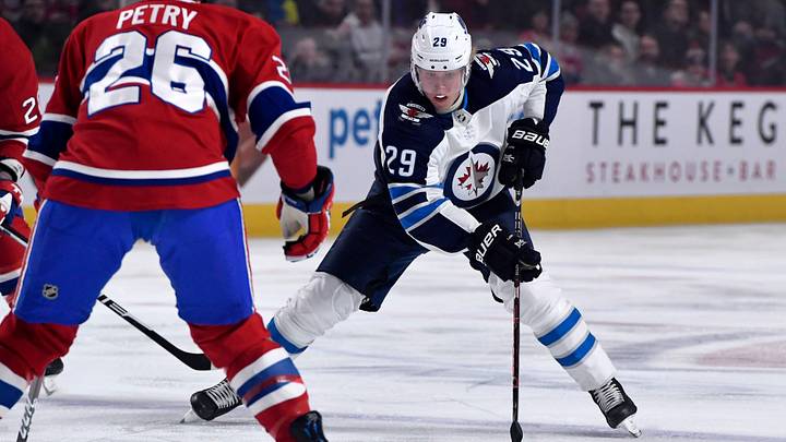 Feb 7, 2019; Montreal, Quebec, CAN; Winnipeg Jets forward Patrick Laine (29) skates with the puck as Montreal Canadiens defenseman Jeff Petry (26) defends during the first period at the Bell Centre. Mandatory Credit: Eric Bolte-USA TODAY Sports