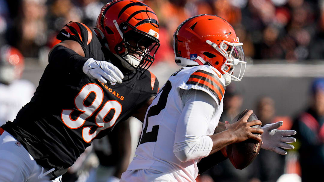 Jan 4, 2026; Cincinnati, Ohio, USA; Cincinnati Bengals defensive end Myles Murphy (99) wraps up Cleveland Browns quarterback Shedeur Sanders (12) in the first quarter at Paycor Stadium. Mandatory Credit: Sam Greene-USA TODAY Network via Imagn Images