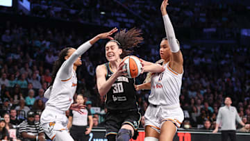 Sep 17, 2025; Brooklyn, New York, USA; New York Liberty forward Breanna Stewart (30) looks to drive past Phoenix Mercury forwards DeWanna Bonner (14) and Satou Sabally (0) during game two of round one for the 2025 WNBA Playoffs at Barclays Center. Mandatory Credit: Wendell Cruz-Imagn Images