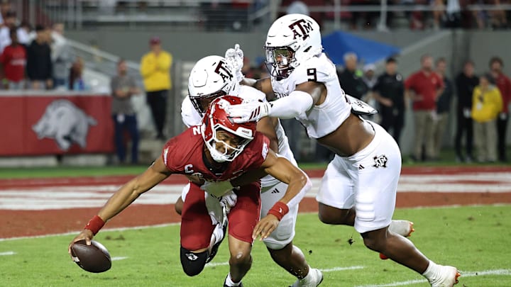 Oct 18, 2025; Fayetteville, Arkansas, USA; Texas A&M Aggies defensive end Dayon Hayes (50) sacks Arkansas Razorbacks quarterback Taylen Green (10) during the fourth quarter as Aggies defensive end Cashius Howell (9) closes in at Donald W. Reynolds Razorback Stadium. Mandatory Credit: Nelson Chenault-Imagn Images